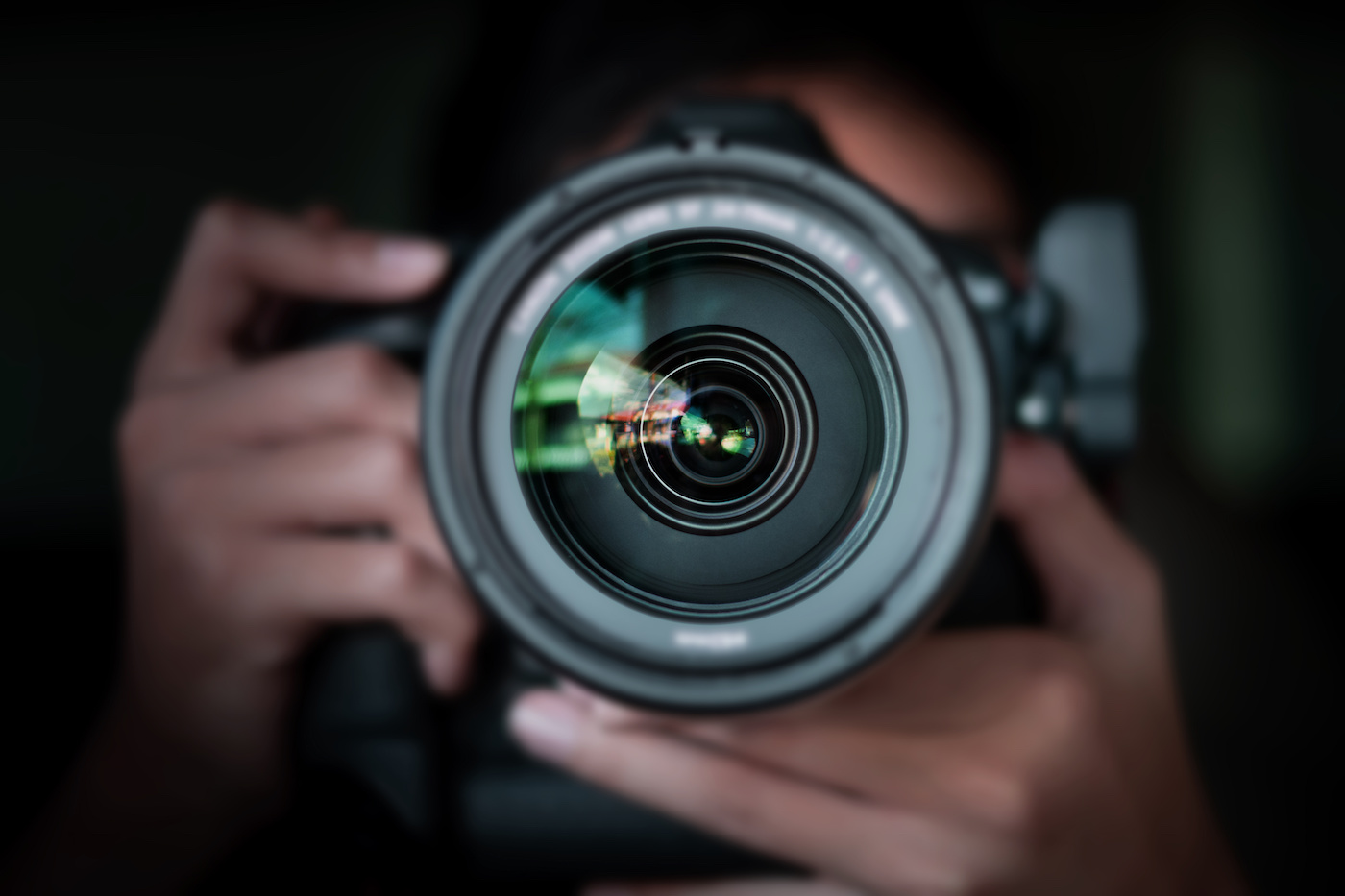 photographer take pictures Snapshot with camera. man hand holding with camera looking through lens.Concept for photographing articles Professionally.